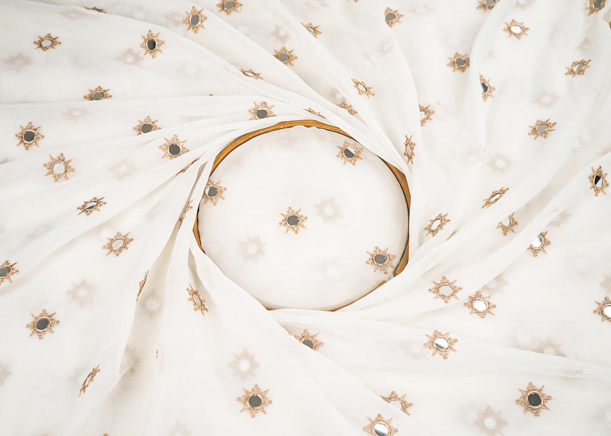 White Georgette Dyeable Fabric With All Over Buti Of Golden Zari And Faux Mirror Work PG 22409